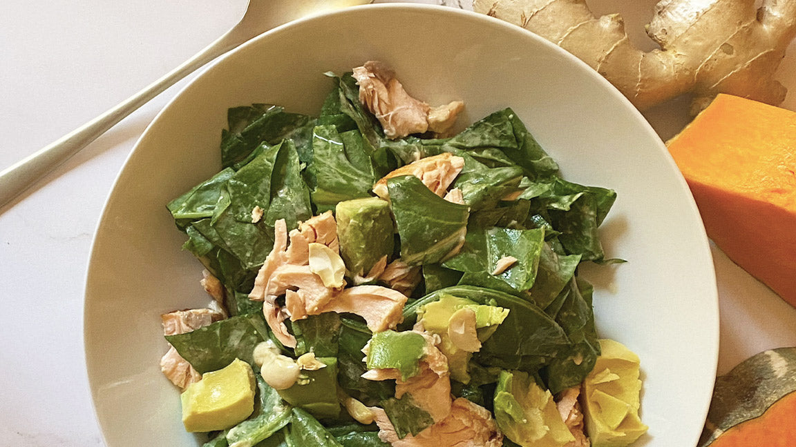 Salmon spinach salad with pumpkin seeds, avocado, with tahini, ginger dressing
